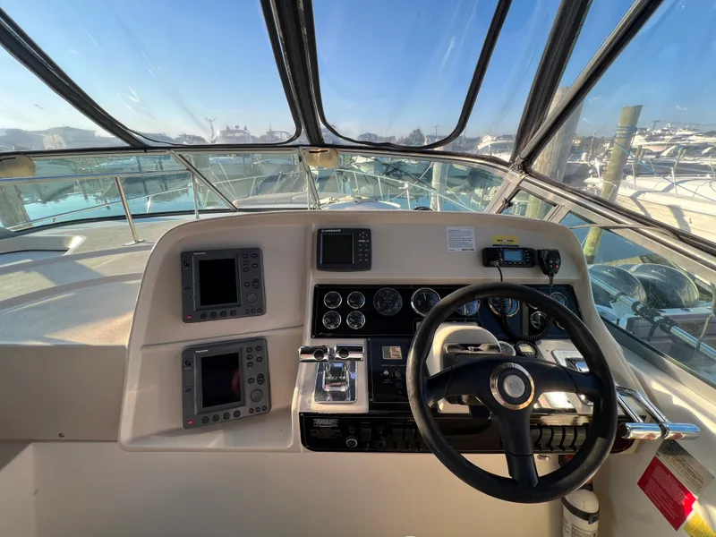 Slide: The Image of 1999 Cruisers Yachts 3575 Esprit helm with navigation instruments and steering wheel. - 15