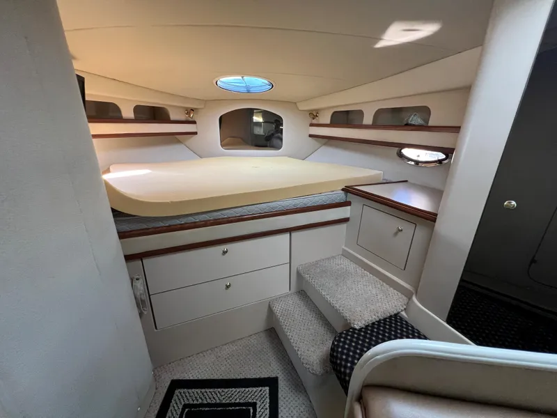 Slide: The Image of 1999 Cruisers Yachts 3575 Esprit cabin interior with bed, storage, and steps. - 23