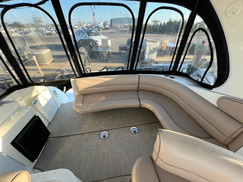 Slide: The Image of 1999 Cruisers Yachts 3575 Esprit interior with beige seating and panoramic windows. - 3