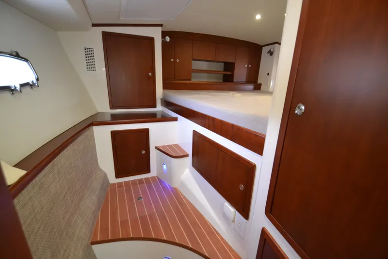Slide: The Image of Luxurious interior of 2022 ArrowCat 42 Coupe with wooden cabinetry and cozy sleeping area. - 11