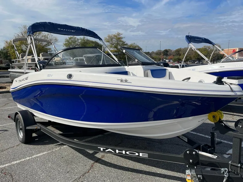 The Image of 2024 Tahoe 185 S boat in blue and white on a trailer. - 0