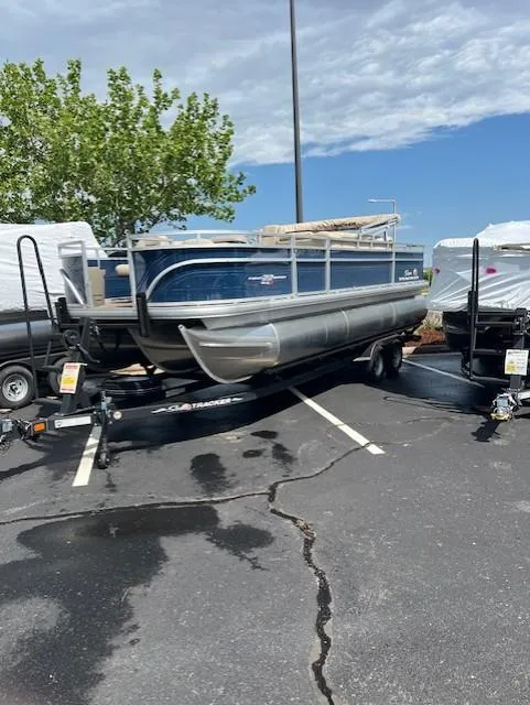 Slide: The Image of 2024 Sun Tracker Fishin' Barge 22 XP3 pontoon boat on trailer in parking lot. - 4