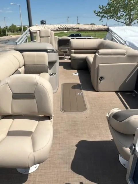 Slide: The Image of 2024 Sun Tracker Fishin' Barge 22 XP3 interior with beige seating and spacious layout. - 5