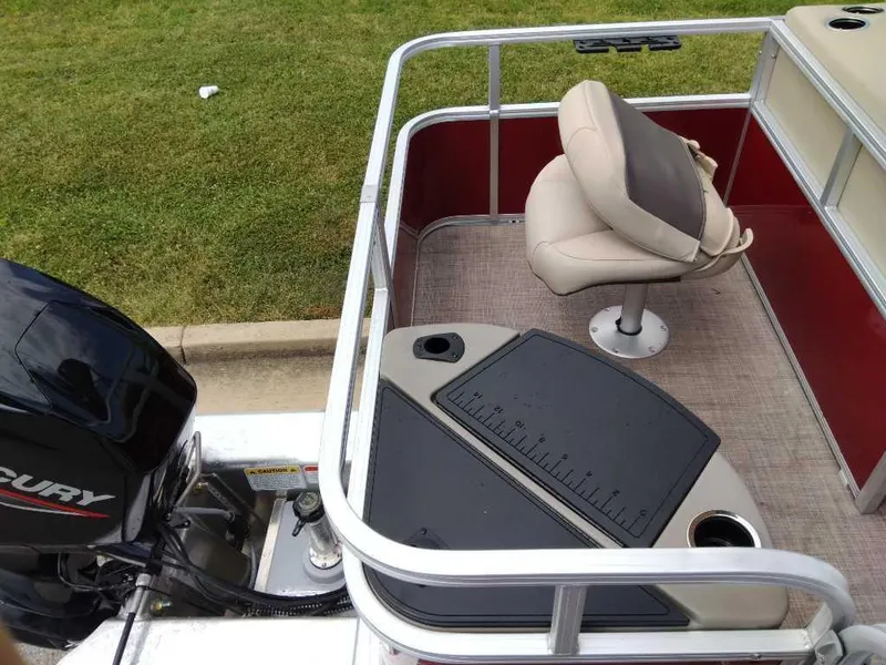 Slide: The Image of 2024 Sun Tracker Bass Buggy 18 DLX pontoon boat with Mercury outboard motor. - 3