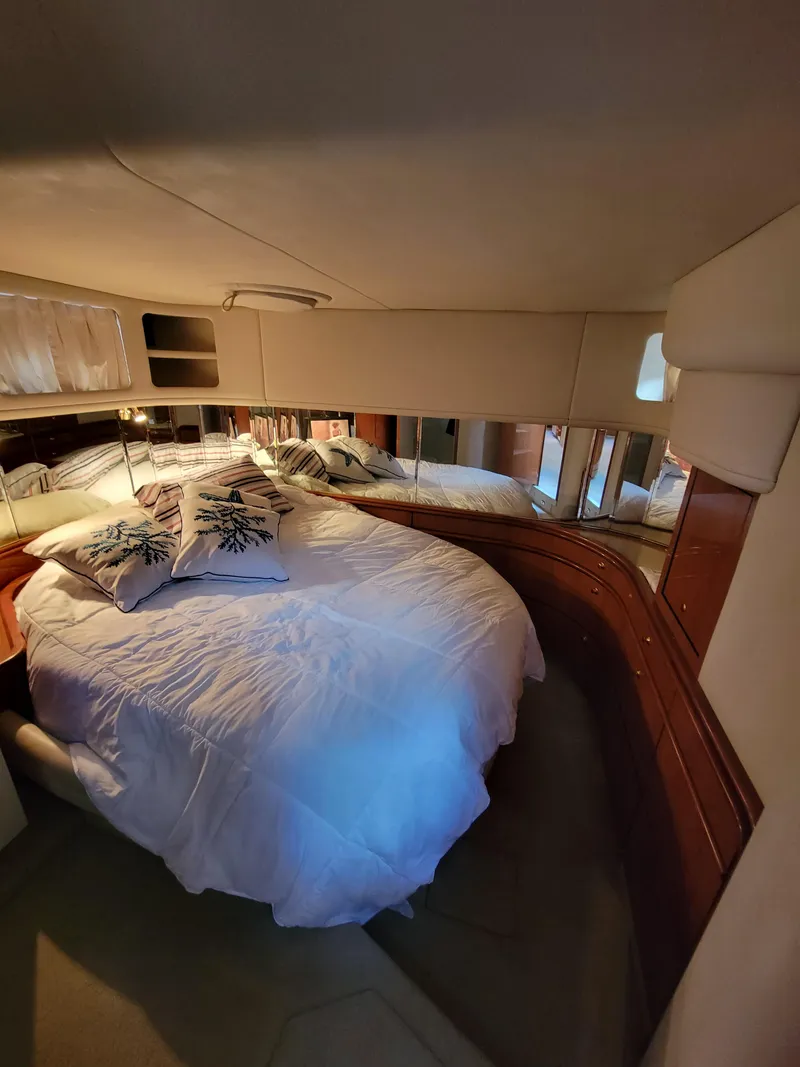 Slide: The Image of Luxurious bedroom in 2000 Sea Ray 540 Sundancer yacht with cozy bedding. - 31