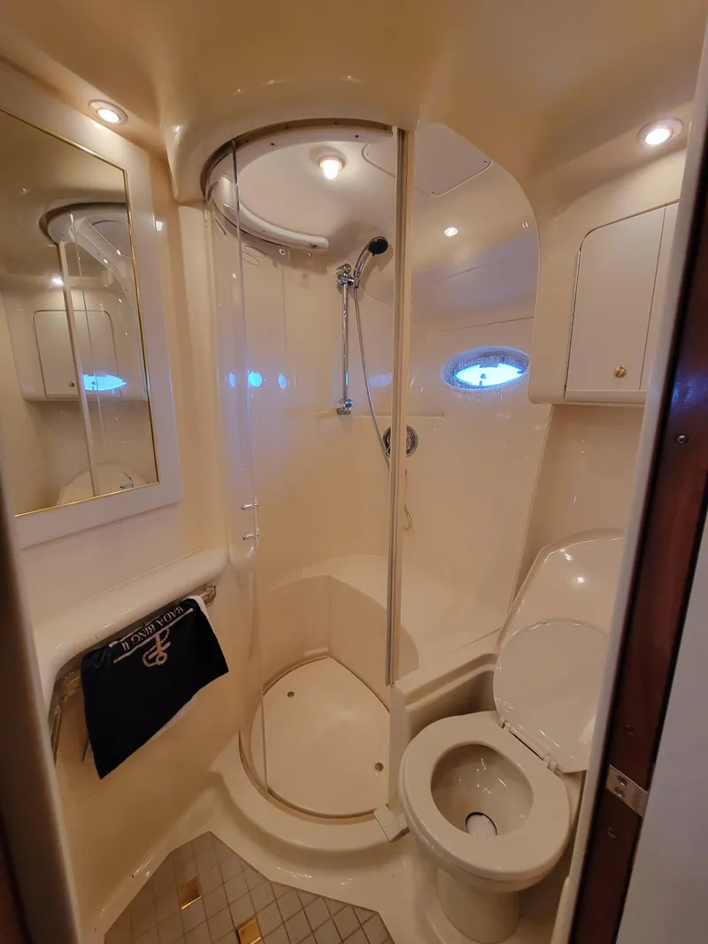 Slide: The Image of 2000 Sea Ray 540 Sundancer bathroom with shower, toilet, and mirror. - 34