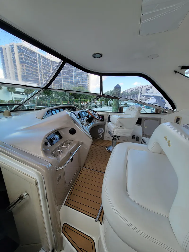 Slide: The Image of Interior of 2000 Sea Ray 540 Sundancer yacht with modern helm and white seating. - 11