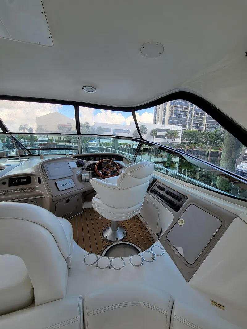 Slide: The Image of Interior helm of 2000 Sea Ray 540 Sundancer yacht with modern controls and white seating. - 7
