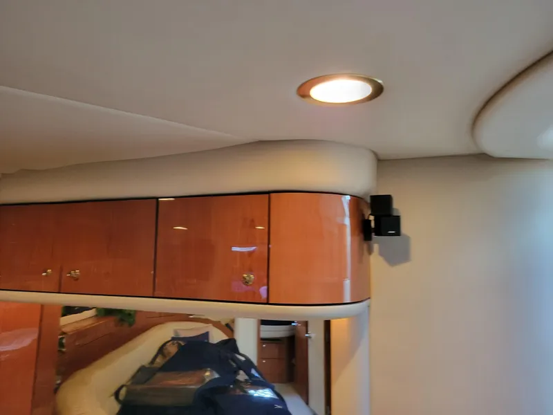 Slide: The Image of 2000 Sea Ray 540 Sundancer interior with wooden cabinets and recessed lighting. - 42