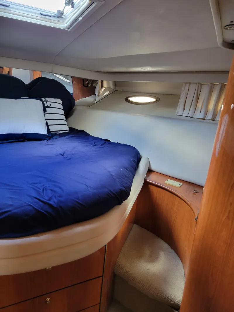 Slide: The Image of Cozy bedroom in 2000 Sea Ray 540 Sundancer yacht with blue bedding. - 46