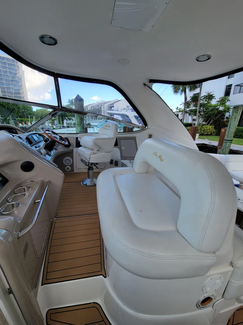 Slide: The Image of Interior of 2000 Sea Ray 540 Sundancer yacht with white leather seating and modern controls. - 12