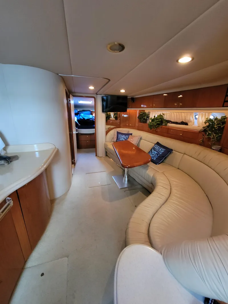 Slide: The Image of Interior of 2000 Sea Ray 540 Sundancer yacht with curved seating and modern amenities. - 38