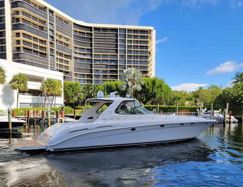 Slide: The Image of 2000 Sea Ray 540 Sundancer yacht cruising near waterfront buildings. - 3