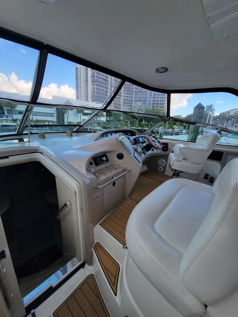 Slide: The Image of Interior view of 2000 Sea Ray 540 Sundancer yacht cockpit with white seating. - 10