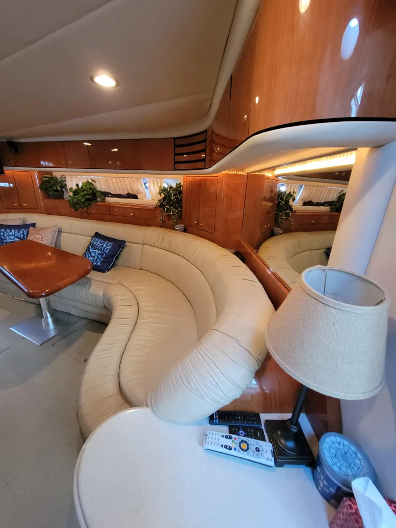 Slide: The Image of Luxurious interior of a 2000 Sea Ray 540 Sundancer yacht with curved seating and wooden finishes. - 39