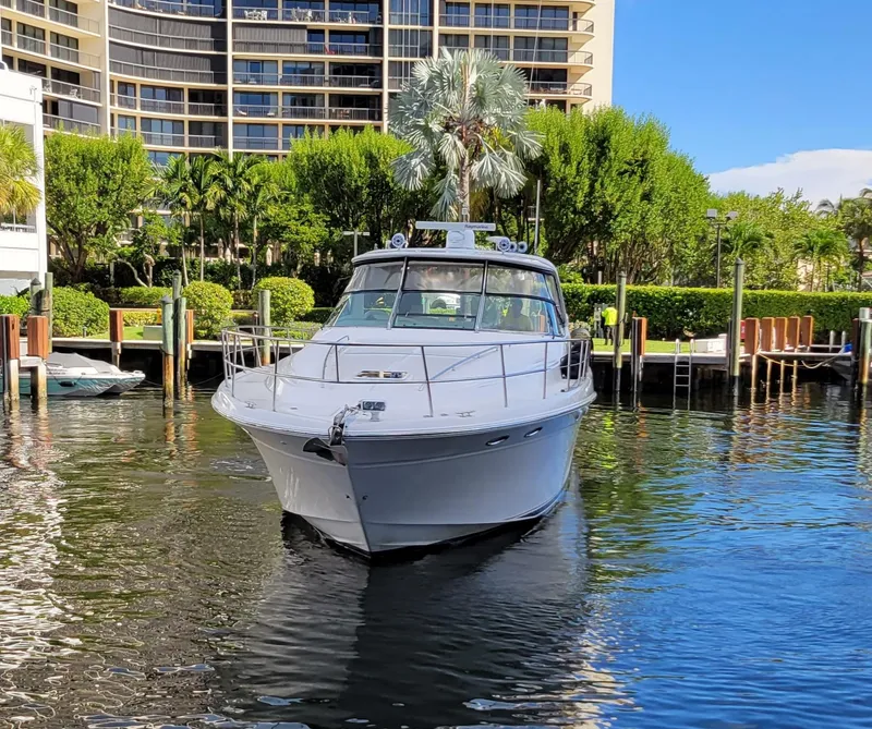 Slide: The Image of 2000 Sea Ray 540 Sundancer yacht docked in a marina with lush greenery. - 4