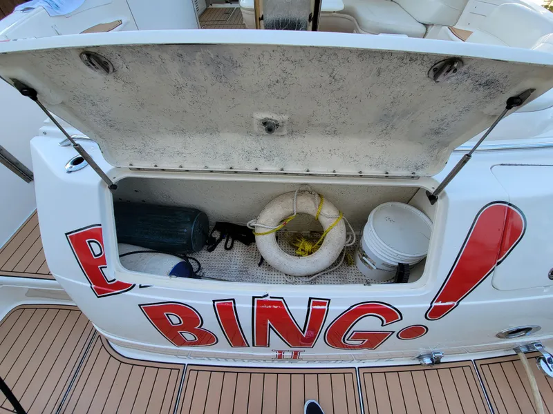 Slide: The Image of Storage compartment on a 2000 Sea Ray 540 Sundancer boat with life ring and equipment. - 20