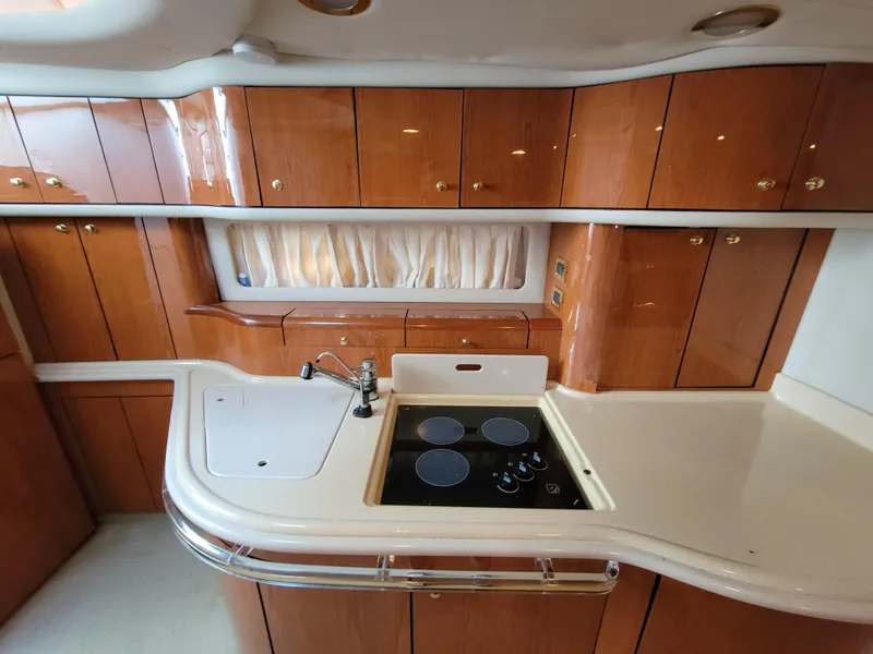 Slide: The Image of 2000 Sea Ray 540 Sundancer yacht kitchen with wooden cabinets and modern appliances. - 29