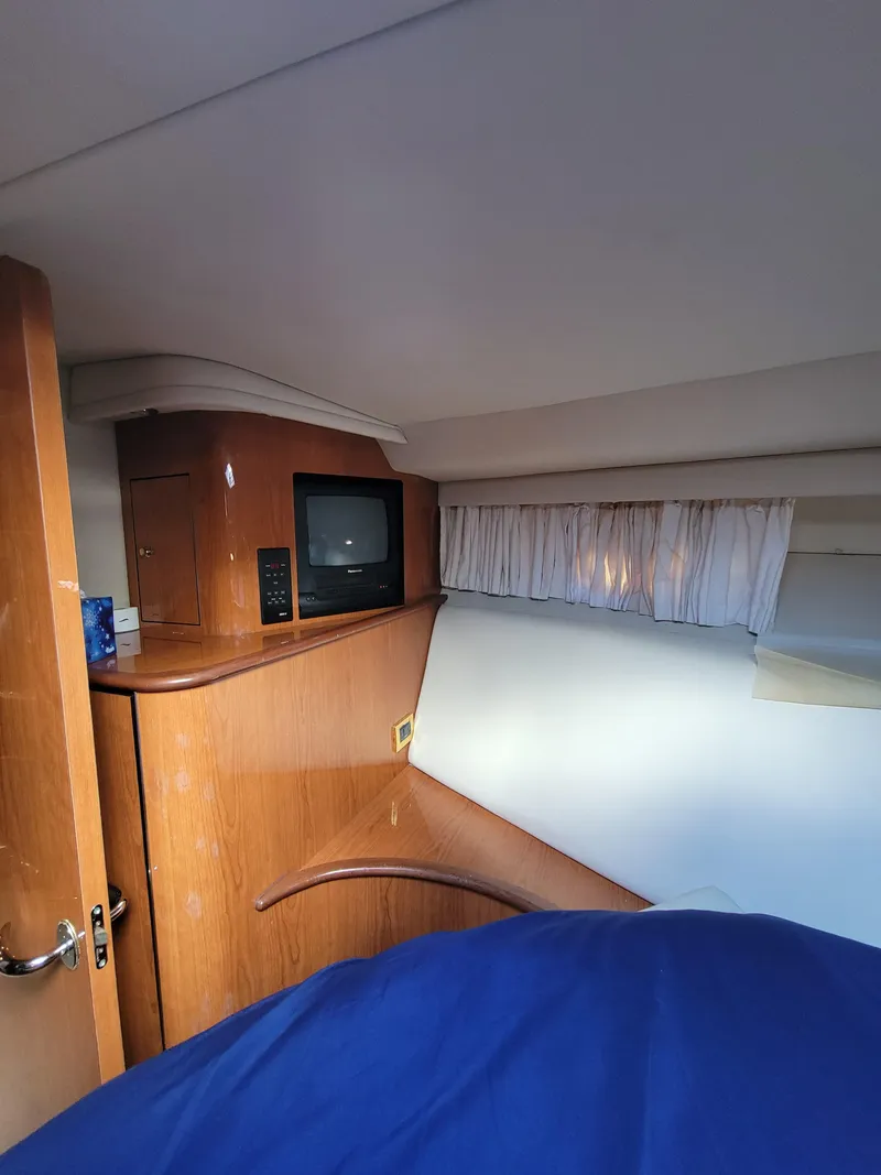 Slide: The Image of Interior cabin of 2000 Sea Ray 540 Sundancer with TV and wooden cabinetry. - 47