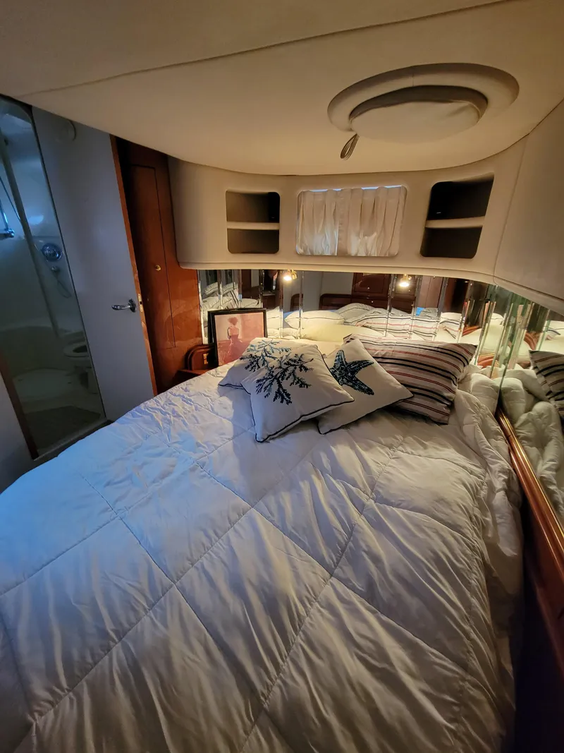 Slide: The Image of Cozy bedroom in a 2000 Sea Ray 540 Sundancer yacht with plush bedding. - 33