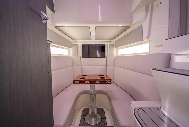 Slide: The Image of Interior of 2021 SeaVee 450z boat with cozy seating and wooden table. - 10