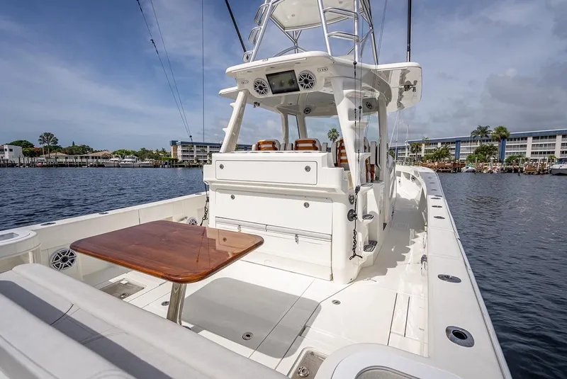 Slide: The Image of 2021 SeaVee 450z boat with spacious deck and seating area on the water. - 6