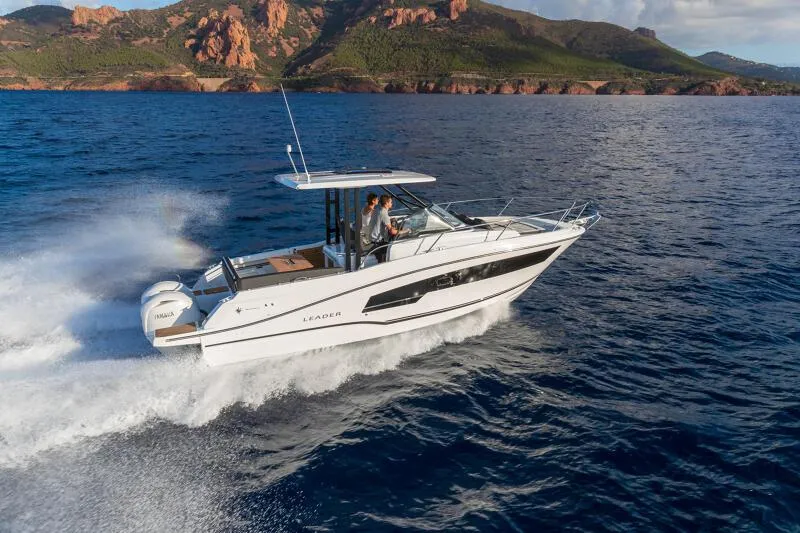 The Image of 2024 Jeanneau Leader 9.0 WA S2 cruising on open water with scenic mountain backdrop. - 0