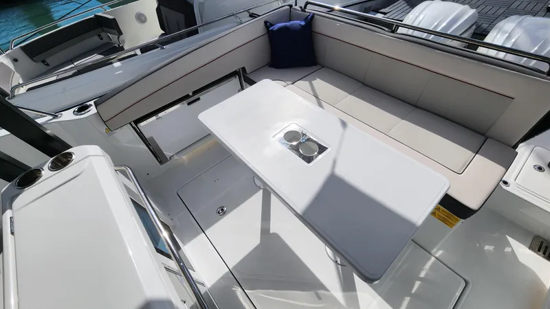 Slide: The Image of 2024 Jeanneau Leader 9.0 WA S2 boat interior with seating and table. - 10