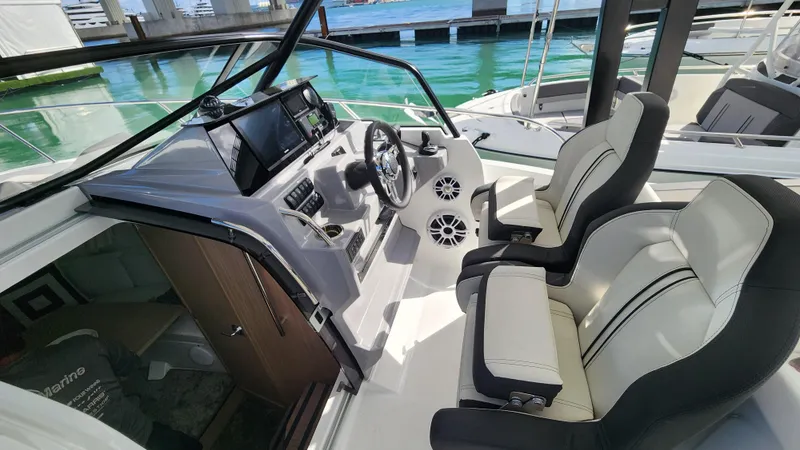 Slide: The Image of 2024 Jeanneau Leader 9.0 WA S2 cockpit with dual seats and modern dashboard. - 14