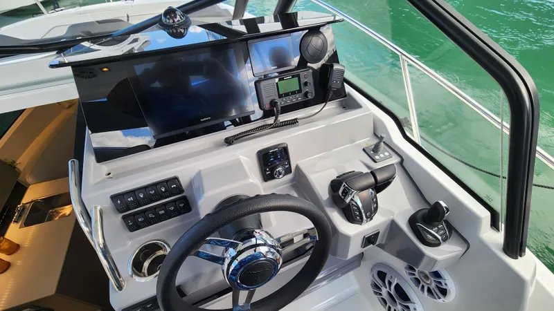 Slide: The Image of 2024 Jeanneau Leader 9.0 WA S2 helm with modern controls and navigation equipment. - 15