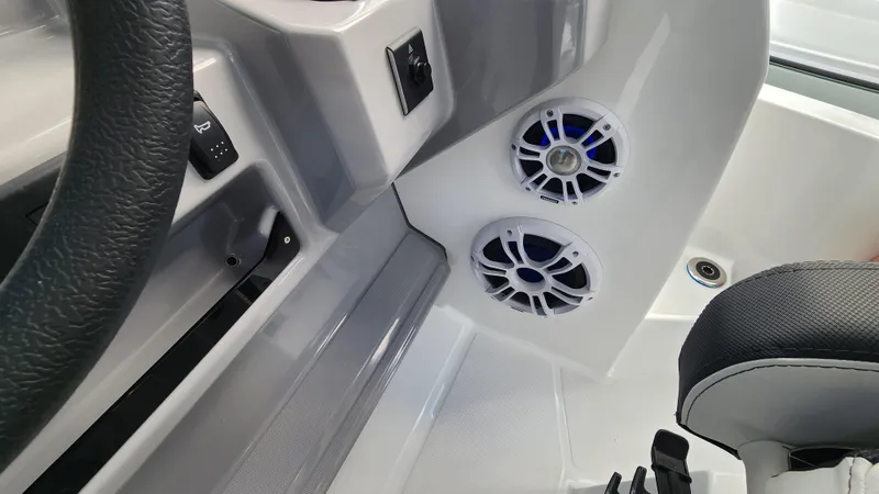 Slide: The Image of 2024 Jeanneau Leader 9.0 WA S2 boat interior with speakers and steering wheel. - 16