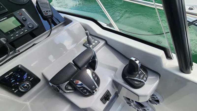 Slide: The Image of 2024 Jeanneau Leader 9.0 WA S2 boat cockpit with modern controls and navigation equipment. - 17