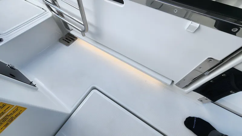 Slide: The Image of 2024 Jeanneau Leader 9.0 WA S2 boat deck with non-slip flooring and ambient lighting. - 18