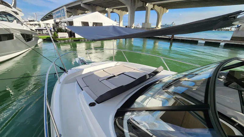 Slide: The Image of 2024 Jeanneau Leader 9.0 WA S2 boat docked under a bridge. - 23