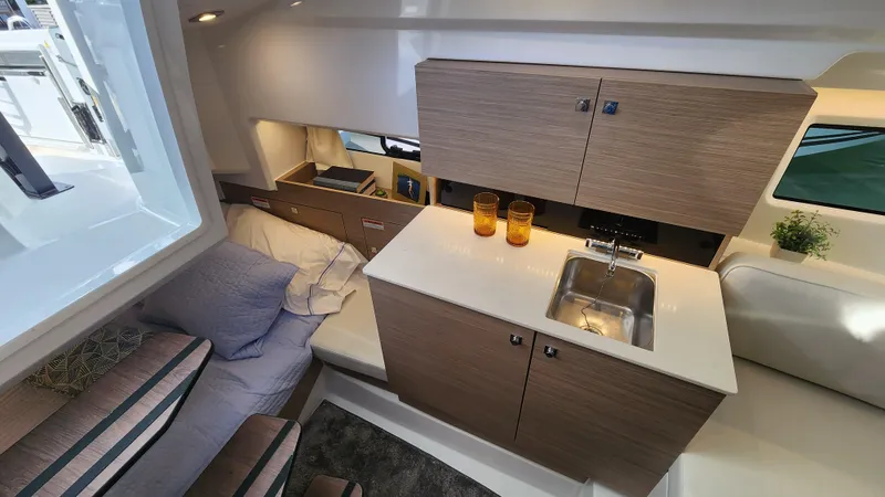 Slide: The Image of 2024 Jeanneau Leader 9.0 WA S2 interior with kitchenette and sleeping area. - 27