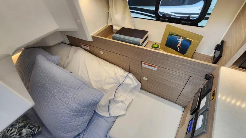 Slide: The Image of Cozy cabin interior of 2024 Jeanneau Leader 9.0 WA S2 with bed and decor. - 30