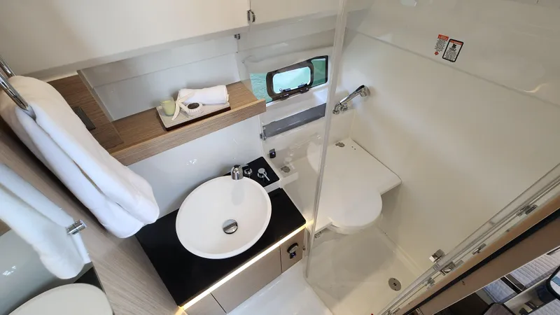 Slide: The Image of Modern bathroom in 2024 Jeanneau Leader 9.0 WA S2 boat with sink, toilet, and shower. - 35