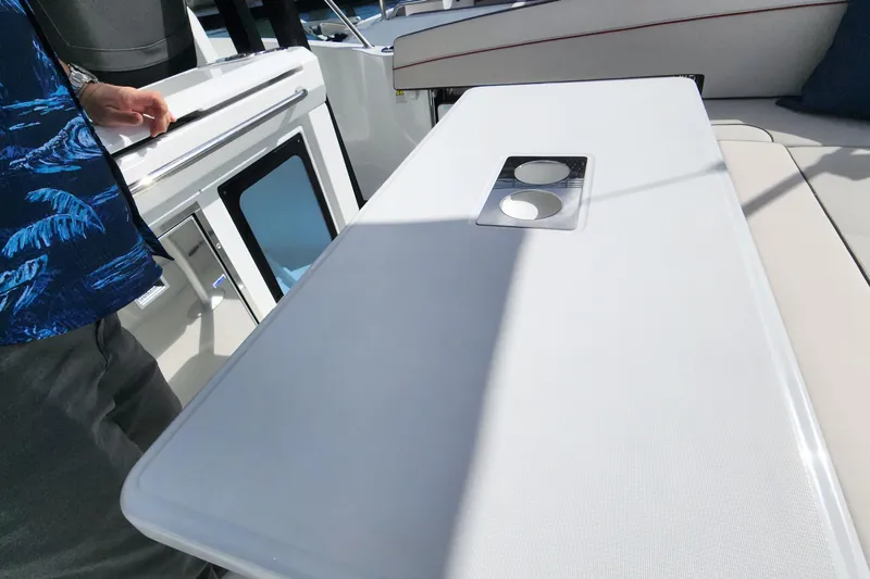 Slide: The Image of 2024 Jeanneau Leader 9.0 WA S2 boat interior with table and cup holders. - 40