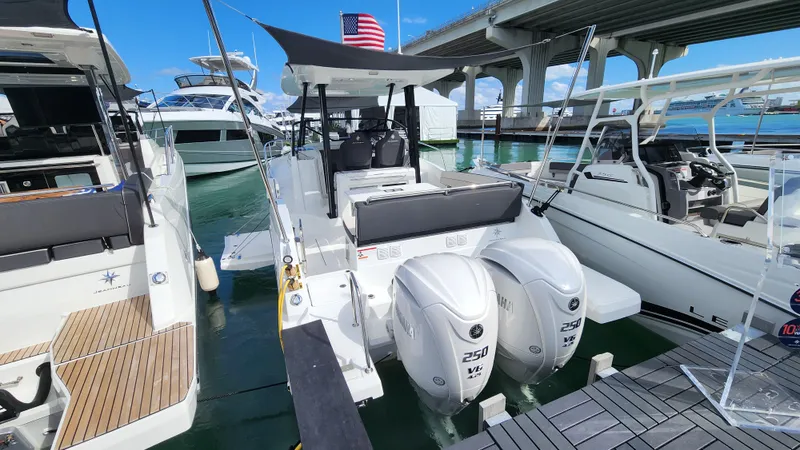 Slide: The Image of 2024 Jeanneau Leader 9.0 WA S2 boat docked with twin 250 HP engines. - 7