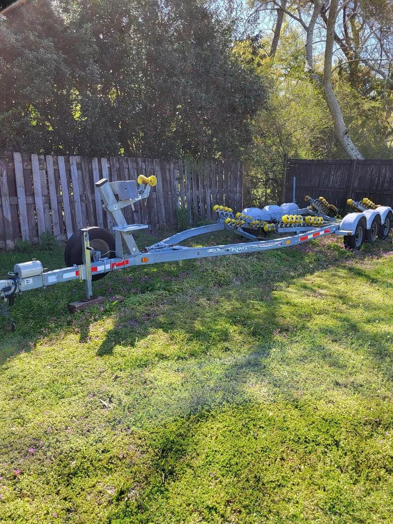 Slide: The Image of 2007 Rosborough 246 Custom Wheel House trailer on grass, near wooden fence, under trees. - 27