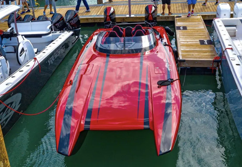 Slide: The Image of 2025 Fountain 34 Thunder Cat powerboat docked, red with black stripes. - 18