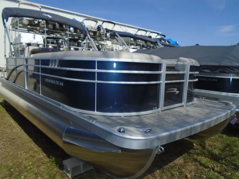 Slide: The Image of 2024 Bennington 21 SXL pontoon boat with sleek design and metallic finish. - 1