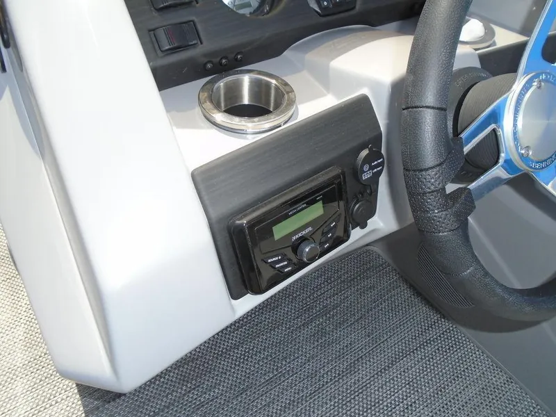 Slide: The Image of 2024 Bennington 21 SXL boat dashboard with stereo system and cup holder. - 19