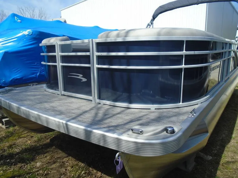 Slide: The Image of 2024 Bennington 21 SXL pontoon boat with blue and silver exterior. - 20