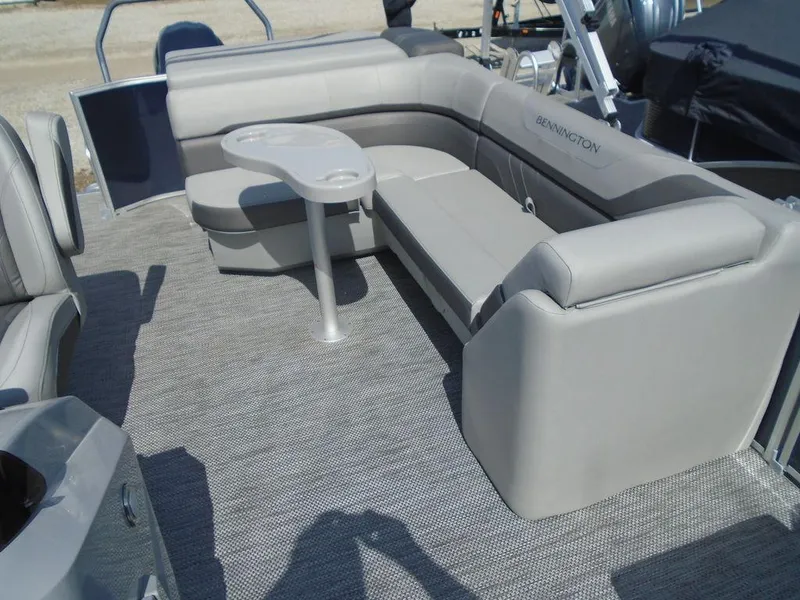 Slide: The Image of 2024 Bennington 21 SXL pontoon boat with spacious seating and table. - 23