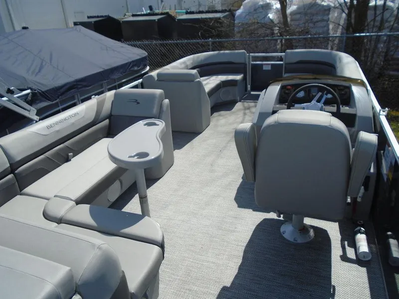 Slide: The Image of 2024 Bennington 21 SXL pontoon boat interior with spacious seating and helm station. - 27