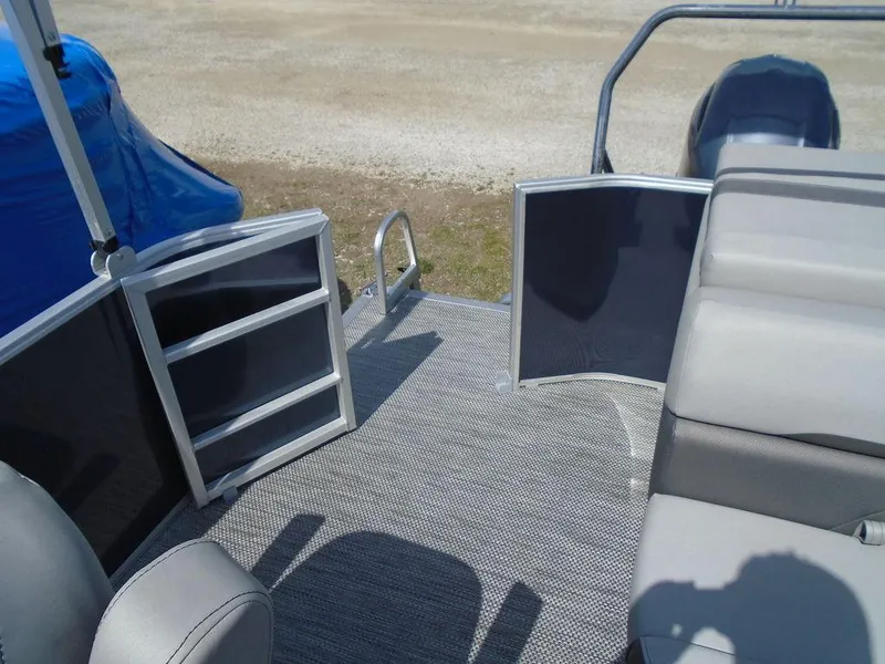 Slide: The Image of 2024 Bennington 21 SXL pontoon boat interior with open gate and seating. - 28