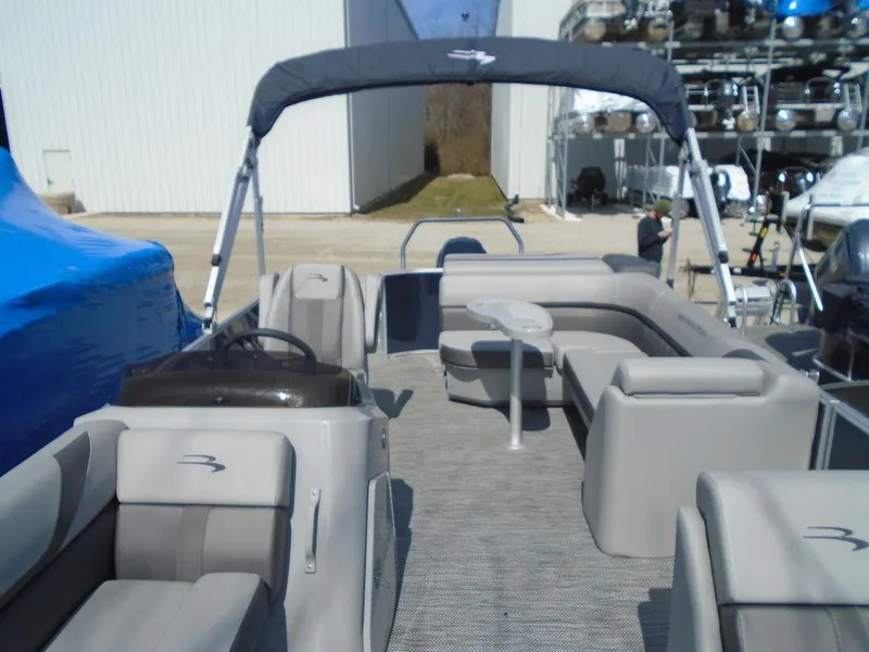 Slide: The Image of 2024 Bennington 21 SXL pontoon boat with spacious seating and canopy. - 5