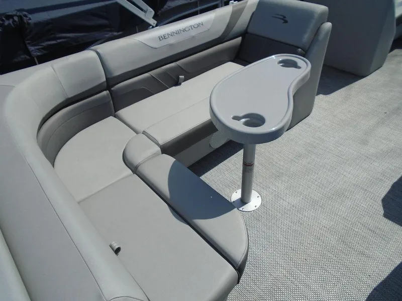 Slide: The Image of 2024 Bennington 21 SXL boat interior with gray seating and table. - 6