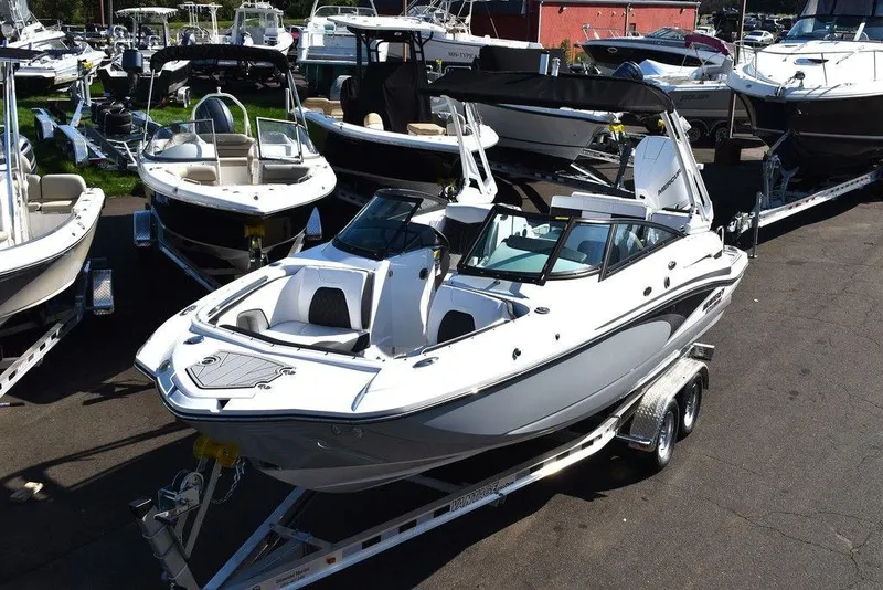 Slide: The Image of 2024 Monterey M-45 boat on trailer in marina, surrounded by other boats. - 1